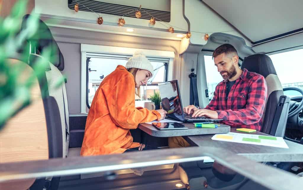 couple working in campervan RV Office