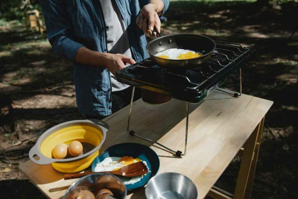 camping table with stove cooking