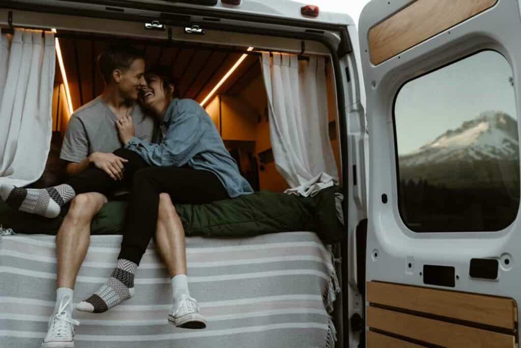 man and woman sitting in campervan