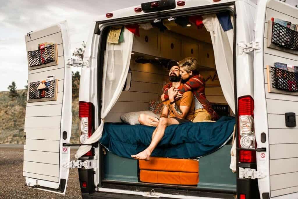 Couple embracing in the back of a van