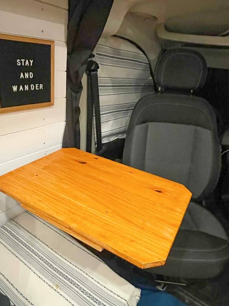 A laguna table in front of a swivel drivers seat in a van