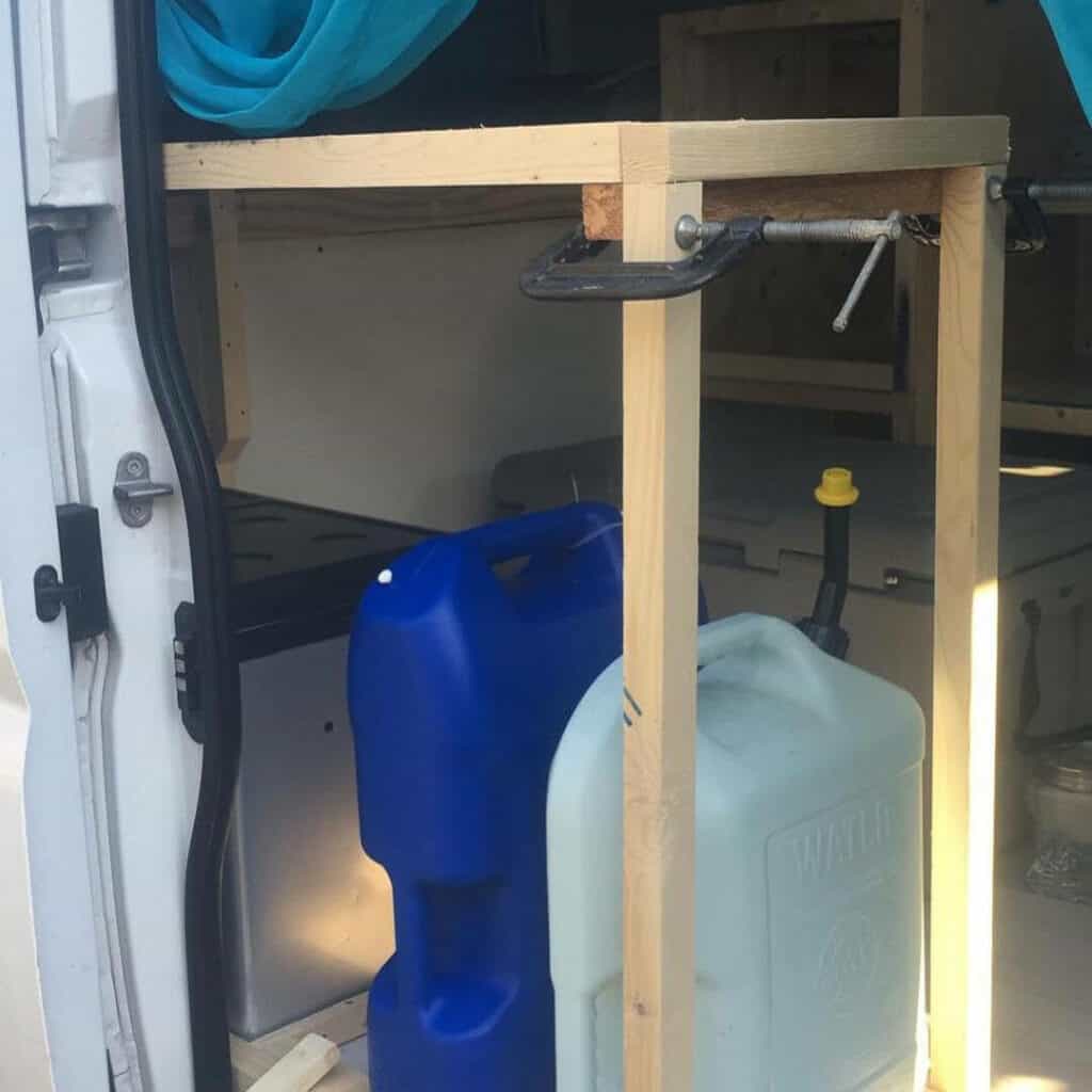 Campervan water setup with portable water containers