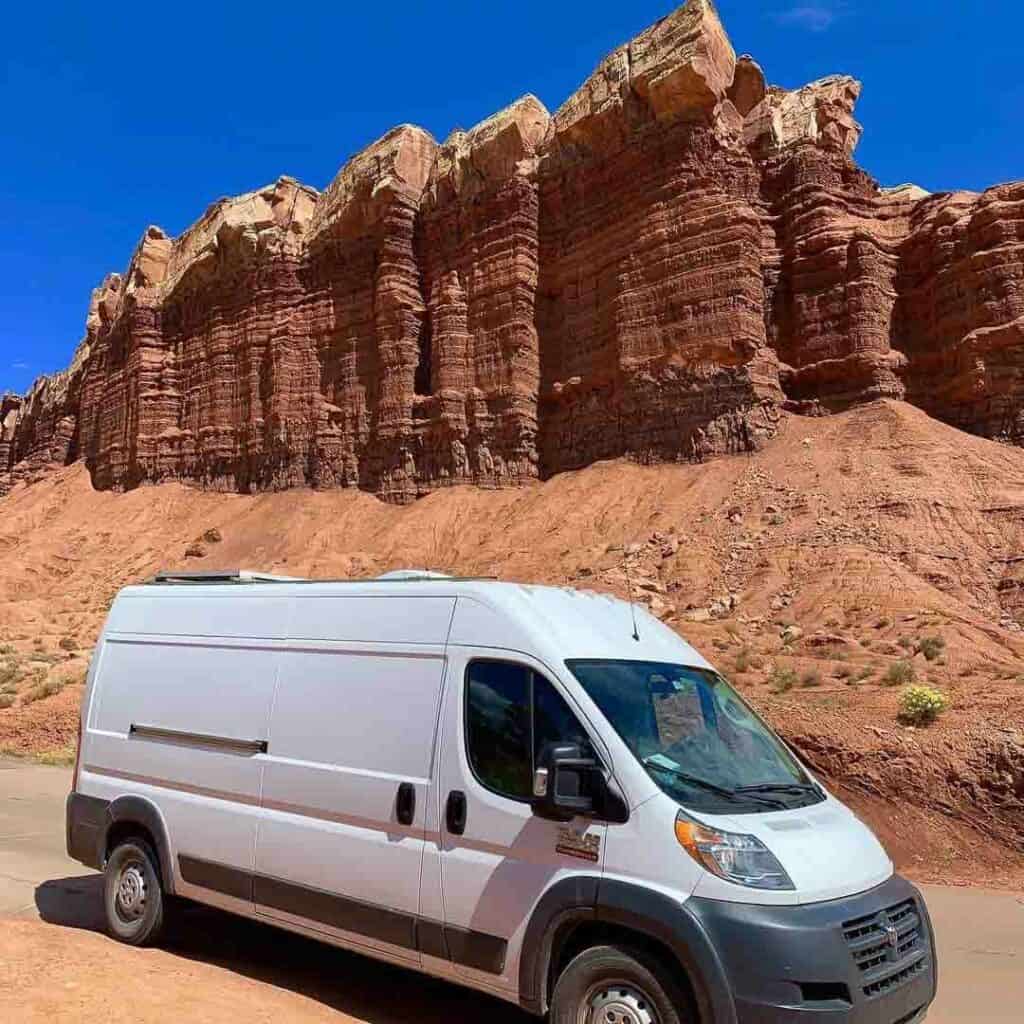 Dodge promaster in front of red rock mountains