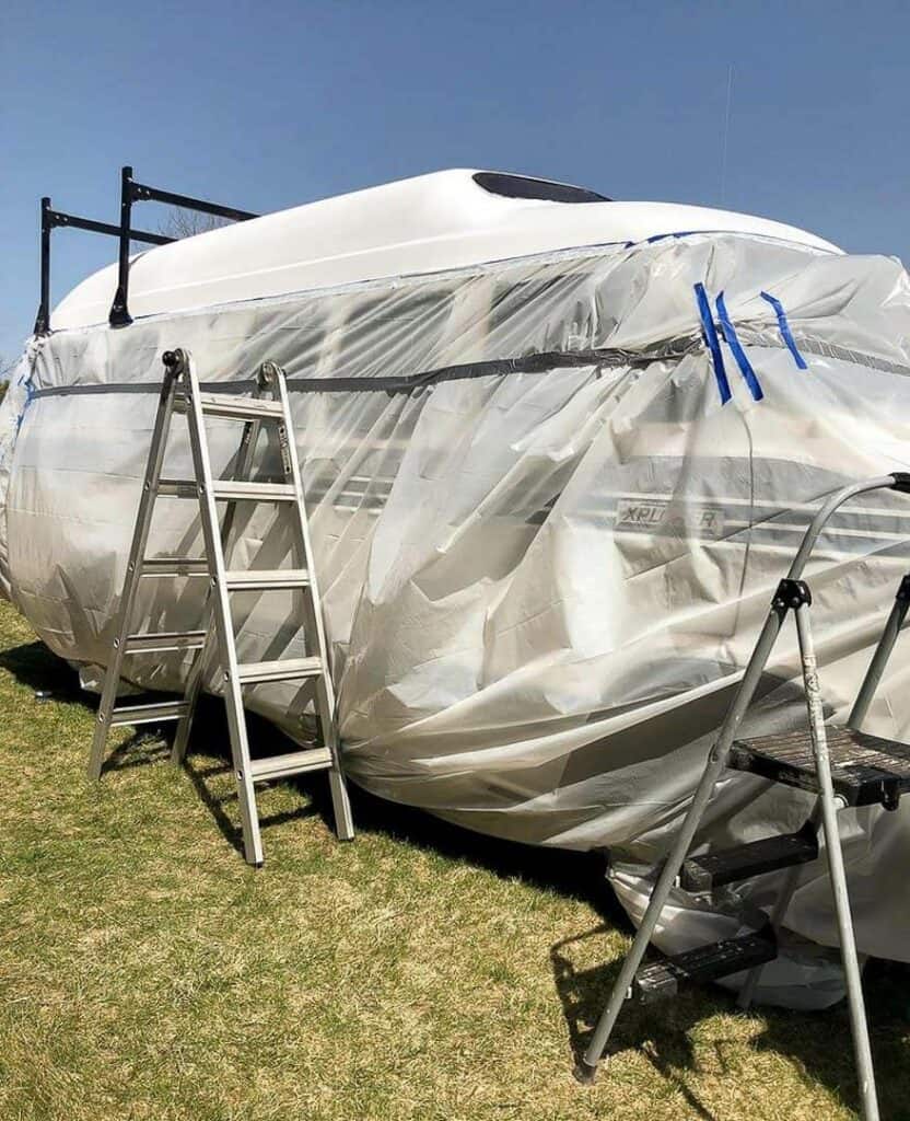A clear tarp placed around a van so the roof can be painted